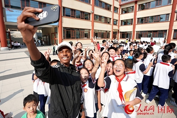 選手和學(xué)生們合影。人民網(wǎng) 盧鵬宇攝