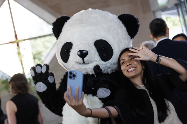 2022年8月24日，在美國華盛頓中國駐美國大使館，來賓與大熊貓玩偶合影。