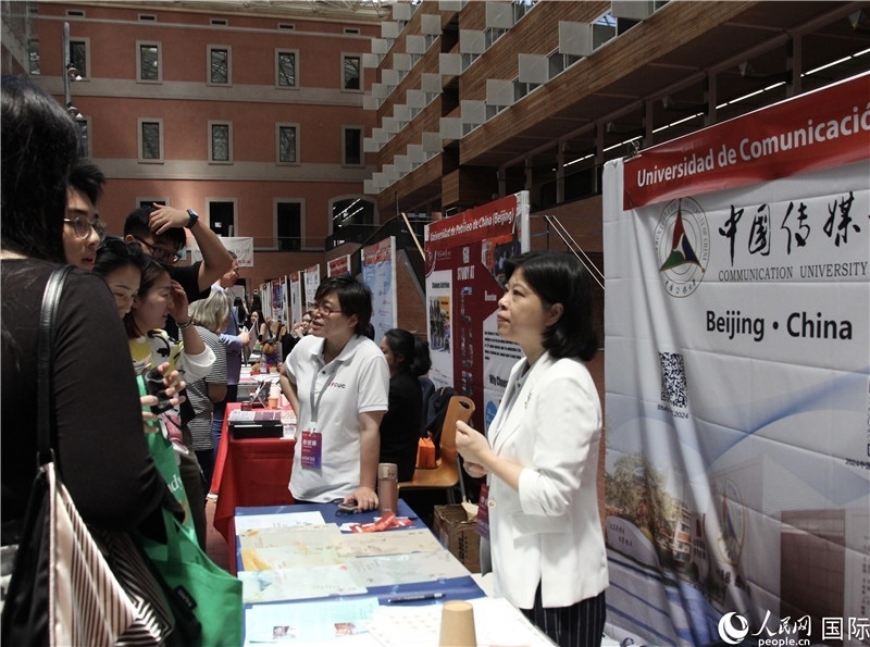 旅西華人華僑在展臺(tái)前咨詢。人民網(wǎng)記者 許海林?jǐn)z