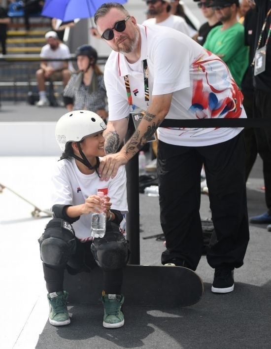 6月20日，鄭好好（左）在比賽間隙與教練互動，她在預(yù)賽中最佳成績?yōu)?2.60分。當(dāng)日，巴黎奧運(yùn)會資格系列賽布達(dá)佩斯站滑板女子碗池預(yù)賽在布達(dá)佩斯舉行。新華社記者 賀燦鈴 攝