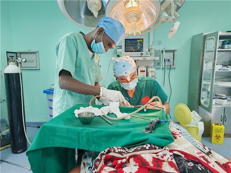 李廣醫(yī)生與當(dāng)?shù)蒯t(yī)生在做手術(shù)中。中國(guó)援桑醫(yī)療隊(duì)供圖