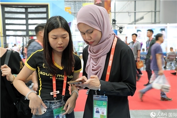 東博會(huì)現(xiàn)場(chǎng)，馬來(lái)西亞展商在同中方工作人員交談。人民網(wǎng)記者 趙益普攝