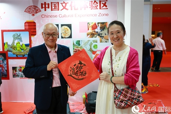 本地觀眾在中國文化體驗區(qū)展示書法作品。人民網(wǎng)記者 白元琪攝