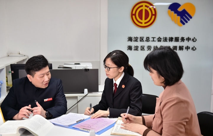 2025年3月6日，在北京市海淀區(qū)總工會勞動爭議調解中心，海淀區(qū)人民法院法官王琰（中）與該中心工作人員就糾紛化解情況進行溝通。新華社記者 趙婷婷 攝