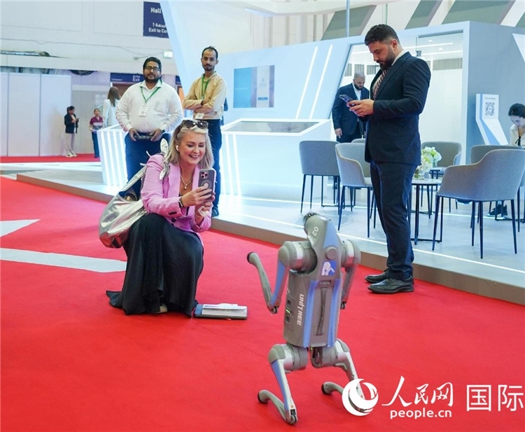 與會嘉賓被中企機器人吸引。人民網(wǎng) 塔里克·易卜拉欣攝